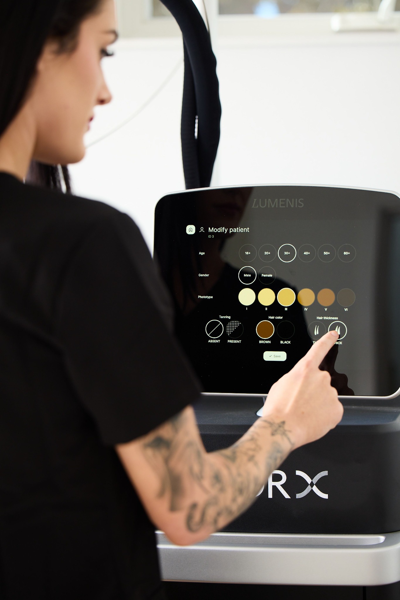 Clara selecting a client’s skin and hair characteristics on the Lumenis Splendor X screen